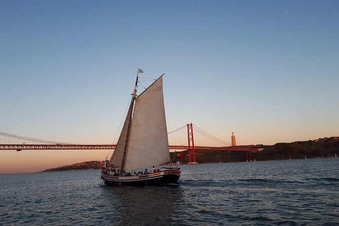 2-Hour Lisbon Traditional Boats Sunset Cruise with White Wine - Leaving Lisbon beneath the 25 de Abril Bridge