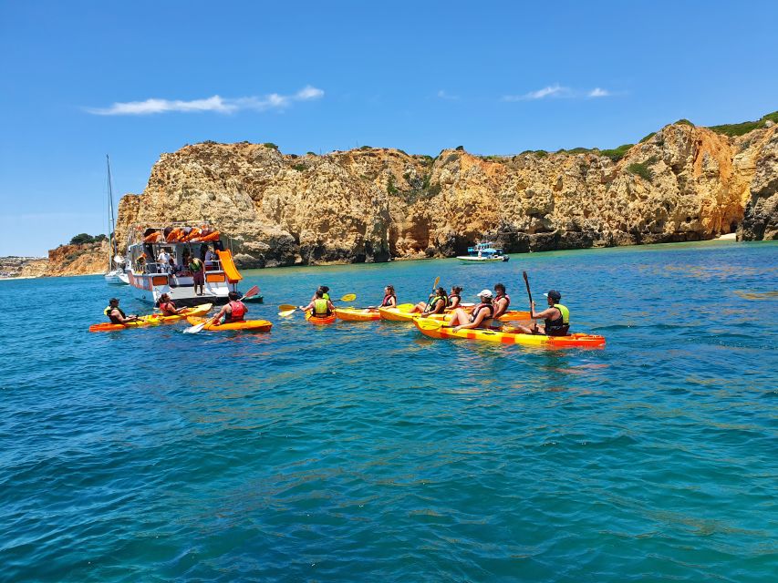 From Lagos: Ponta da Piedade Caves Kayak Tour from Catamaran - Sliding into the kayak at Ponta da Piedade