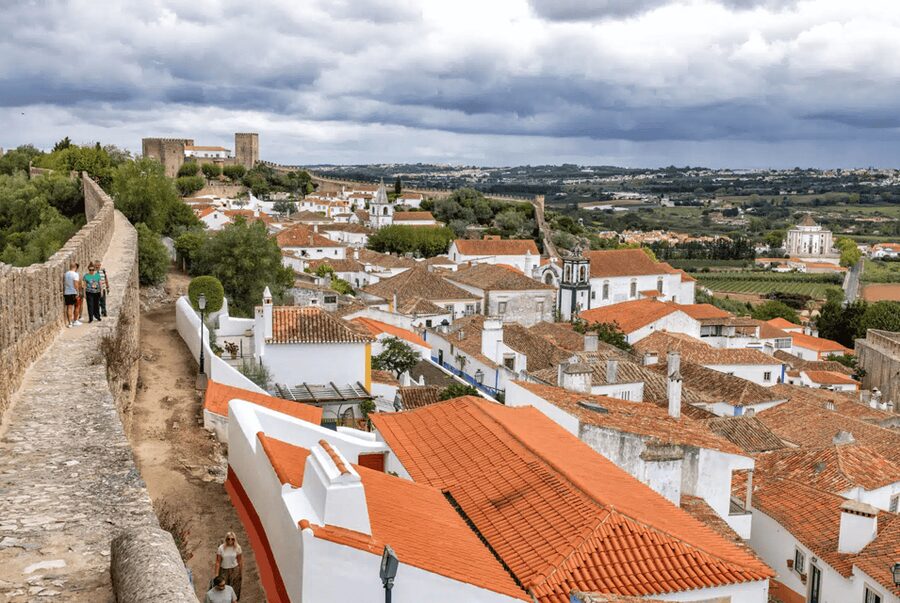 From Lisbon: Nazare Big Waves and Óbidos Guide Day Trip - Seeing Nazaré from the beach