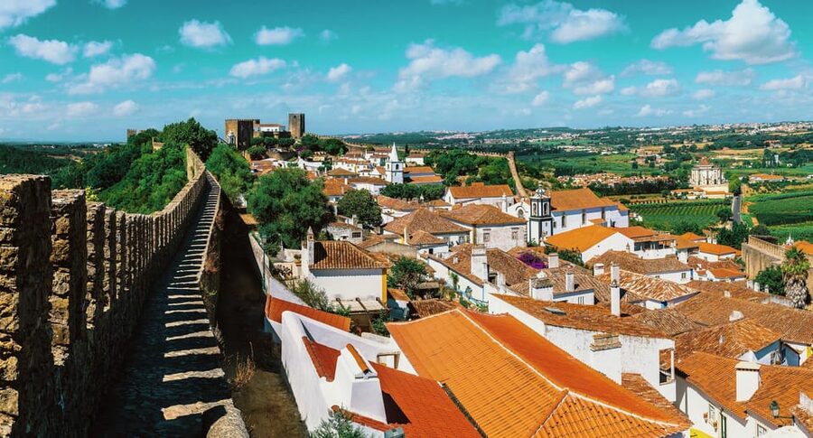 From Lisbon: Nazare Big Waves and Óbidos Guide Day Trip - Walking the walls and tasting Ginjinha