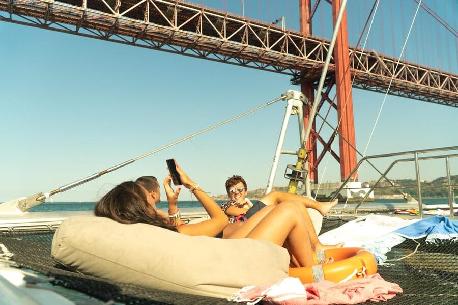 Lisbon: Catamaran Boat Party with Music, Open Bar & Dives - Cruising past Algés and Lisbon’s western waterfront