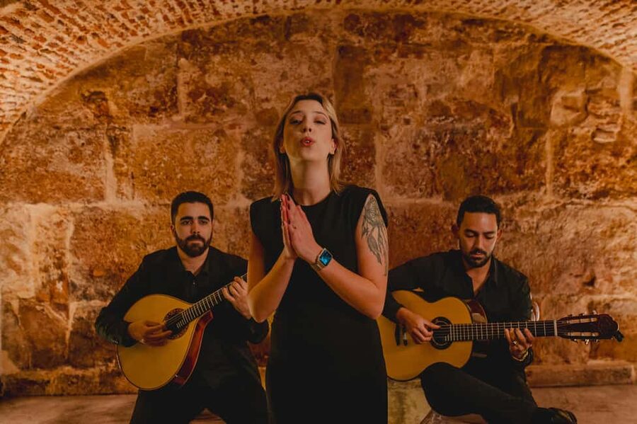 Lisbon: Fado Show with Wine in a Historic Venue - Entering through the blue doors near Lisbon Sé Cathedral