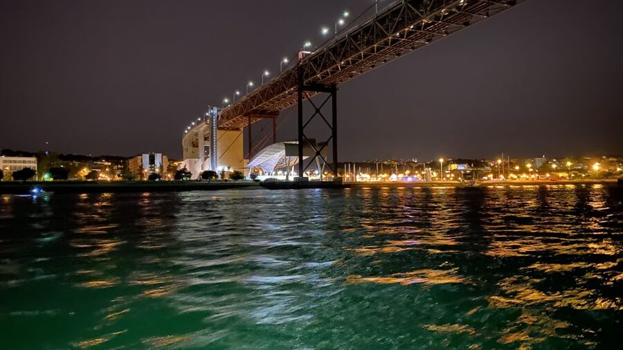 Lisbon: Luxury Sailboat Cruise at Night - Passing beneath the 25 de Abril Bridge