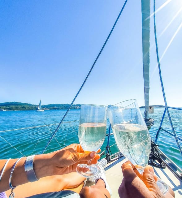 Lisbon: "Sunset" & "Day Tours" by boat, with drink and music - Belém Tower from the water