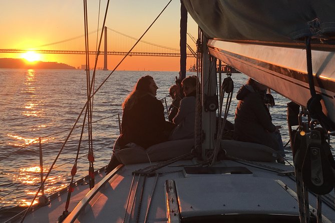 Lisbon Sunset Sailing Tour with White or Rosé Wine and Snacks - Crossing beneath the 25 de Abril Bridge